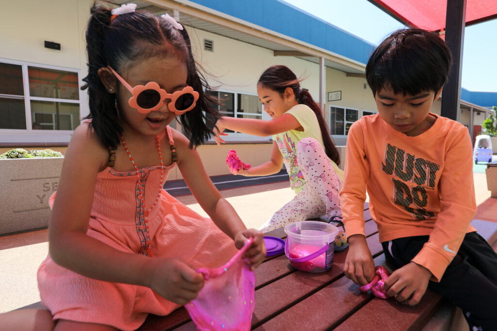 Rylee playing with two friends outdoors
