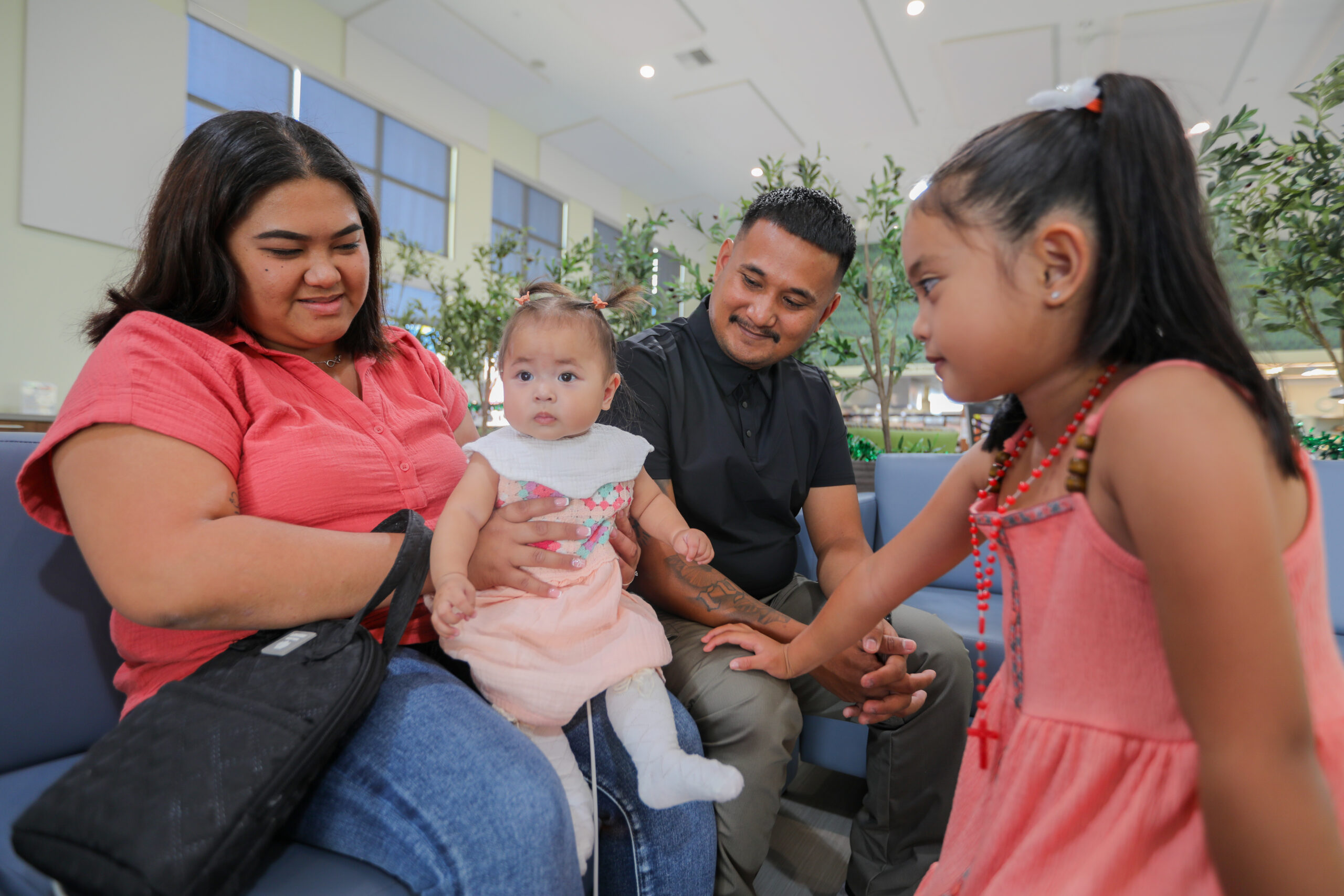 The De Leon Guerrero family—Dasery, Jesse, Rylee, and Remi—spend time together in a common area at Ronald McDonald House San Diego.