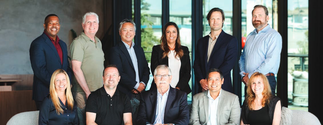 Eleven members of the Board of Trustees pose together in two rows.