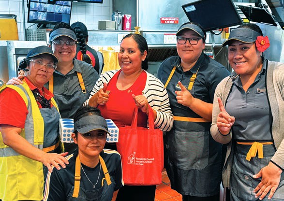 Smiling McDonald’s crew members in uniform stand together at the Paradise Valley Road restaurant.